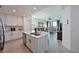 Well-lit kitchen with white cabinets, a center island, stainless appliances and an open layout to the living area at 1010 Tidewater Shores Loop # 201, Bradenton, FL 34208