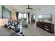 An open living room featuring a couch, TV, and access to a balcony with water views at 1010 Tidewater Shores Loop # 201, Bradenton, FL 34208