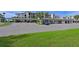 Community parking lot featuring covered parking, mature landscaping, and well-maintained asphalt at 1010 Tidewater Shores Loop # 201, Bradenton, FL 34208