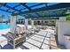 Covered patio with seating and a fire pit, perfect for outdoor gatherings at 1010 Tidewater Shores Loop # 201, Bradenton, FL 34208