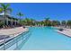 Resort-style pool with ample lounge chairs and a clubhouse in the background at 1010 Tidewater Shores Loop # 201, Bradenton, FL 34208