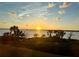 Picturesque waterfront sunset view with palm trees and beautiful sky at 1010 Tidewater Shores Loop # 201, Bradenton, FL 34208