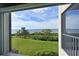 Water view from the porch with green grass and palm trees at 1010 Tidewater Shores Loop # 201, Bradenton, FL 34208