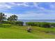 Waterfront property with stunning lake views, lush green landscape, and tropical palms, offering a serene and picturesque setting at 1010 Tidewater Shores Loop # 201, Bradenton, FL 34208