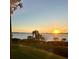 Scenic sunset view over calm water and palm trees at 1010 Tidewater Shores Loop # 201, Bradenton, FL 34208