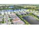 Aerial view showcasing a lakefront community with luxury homes and pools at 10180 Canaveral Cir, Sarasota, FL 34241