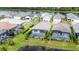 Aerial view of lakefront homes with private pools and screened enclosures at 10180 Canaveral Cir, Sarasota, FL 34241