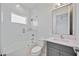 Clean bathroom with a bathtub, shower, and gray vanity at 10180 Canaveral Cir, Sarasota, FL 34241