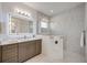 Modern bathroom with gray vanity, quartz countertop, and glass shower at 10180 Canaveral Cir, Sarasota, FL 34241