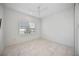 Bright bedroom with tile flooring and window with shutters at 10180 Canaveral Cir, Sarasota, FL 34241