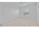 Bright bedroom featuring tile flooring and window with shutters at 10180 Canaveral Cir, Sarasota, FL 34241