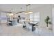 Bright dining area features a modern table and chairs with stylish lighting at 10180 Canaveral Cir, Sarasota, FL 34241