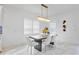 Dining area with dark gray table and white chairs at 10180 Canaveral Cir, Sarasota, FL 34241