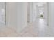 Bright and airy entryway with marble-look tile floors at 10180 Canaveral Cir, Sarasota, FL 34241