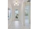 Bright and airy entryway with marble-look tile floors at 10180 Canaveral Cir, Sarasota, FL 34241
