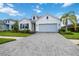 Charming one-story home with light gray siding and a light blue garage door at 10180 Canaveral Cir, Sarasota, FL 34241