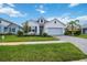 Charming one-story home with light gray siding and a light blue garage door at 10180 Canaveral Cir, Sarasota, FL 34241