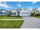 Charming one-story home with light gray siding and a light blue garage door at 10180 Canaveral Cir, Sarasota, FL 34241