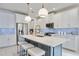 Modern kitchen with white cabinets, large island, and quartz countertops at 10180 Canaveral Cir, Sarasota, FL 34241