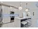 Modern kitchen with white cabinets, large island, and stainless steel appliances at 10180 Canaveral Cir, Sarasota, FL 34241