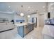 Open kitchen boasts a large island, stainless steel appliances, and stylish backsplash at 10180 Canaveral Cir, Sarasota, FL 34241