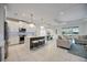 Open concept kitchen with white cabinets and island seating at 10180 Canaveral Cir, Sarasota, FL 34241