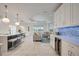 Open concept kitchen with white cabinets and island seating at 10180 Canaveral Cir, Sarasota, FL 34241