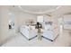 Bright and airy living room with comfortable sofas and a view to the kitchen at 10180 Canaveral Cir, Sarasota, FL 34241