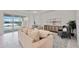 Living room with beige sofa and view of pool and lake at 10180 Canaveral Cir, Sarasota, FL 34241