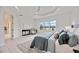Bright and airy main bedroom with king bed, sitting area and access to the bathroom at 10180 Canaveral Cir, Sarasota, FL 34241