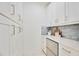 Walk-in pantry with white cabinets and quartz countertops at 10180 Canaveral Cir, Sarasota, FL 34241