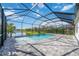 Relaxing screened pool and patio area overlooking a lake at 10180 Canaveral Cir, Sarasota, FL 34241