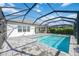 Inviting pool and patio area with covered cage at 10180 Canaveral Cir, Sarasota, FL 34241