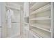 Large walk-in closet with ample shelving and hanging space at 10180 Canaveral Cir, Sarasota, FL 34241