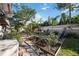 Spacious backyard with a pizza oven, fire pit, and lush greenery at 111 Webb St, Osprey, FL 34229