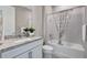 Clean bathroom with granite countertop, white cabinets and shower/tub combo at 12433 Golden Sage Dr, Sarasota, FL 34238