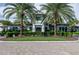 Community clubhouse with palm trees and landscaping at 12433 Golden Sage Dr, Sarasota, FL 34238