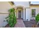 Welcoming entryway with brick walkway and flowering plants at 12433 Golden Sage Dr, Sarasota, FL 34238