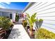 Landscaped backyard with walkway and lush tropical plants at 1256 Spoonbill Landings Cir, Bradenton, FL 34209