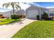 Gray house exterior with a garage and neat landscaping at 1256 Spoonbill Landings Cir, Bradenton, FL 34209