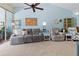 Relaxing living room featuring comfortable sofas and a ceiling fan at 1256 Spoonbill Landings Cir, Bradenton, FL 34209