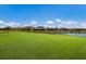 Large backyard with a pond view and fenced area at 13627 American Prairie Pl, Lakewood Ranch, FL 34211