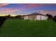 Spacious backyard with lush lawn and a screened patio at 13627 American Prairie Pl, Lakewood Ranch, FL 34211