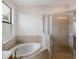 Bathroom with soaking tub and walk-in shower at 13627 American Prairie Pl, Lakewood Ranch, FL 34211