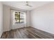 Bright bedroom with large window, wood floors, and ceiling fan at 13627 American Prairie Pl, Lakewood Ranch, FL 34211