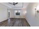 Bright bedroom featuring wood-look floors, window, and access to backyard at 13627 American Prairie Pl, Lakewood Ranch, FL 34211