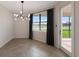 Bright dining room with large window and modern chandelier at 13627 American Prairie Pl, Lakewood Ranch, FL 34211