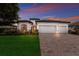 White two-story house with a brick driveway and a three-car garage at 13627 American Prairie Pl, Lakewood Ranch, FL 34211