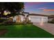 Two-story house with a brick driveway and three-car garage, at sunset at 13627 American Prairie Pl, Lakewood Ranch, FL 34211