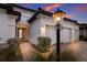 Front entry with a lighted lamp post and brick walkway at 13627 American Prairie Pl, Lakewood Ranch, FL 34211